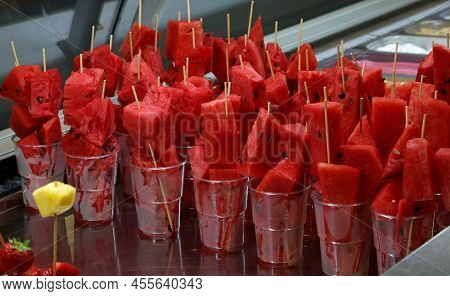Many Skewers Of Large Slices Of Ripe Red Watermelon In The Glasses For Sale In The Bar Of The Beach 