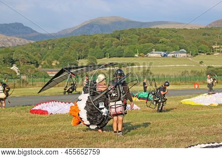 Paramotor And Powered Hangliders Being Prepared In A Field
