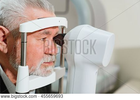 Examination Of Elderly Man On Corneo Topographer.modern Clinic