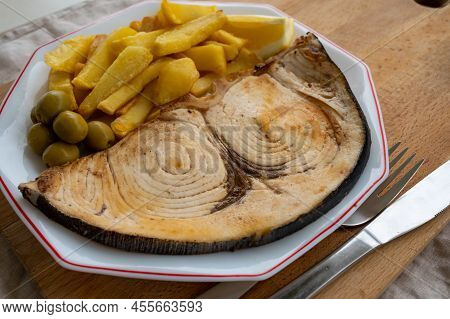 Seafood Dish, Grilled Steak From Swordfish Or Spada Served With French Fried Potatoes And Green Oliv