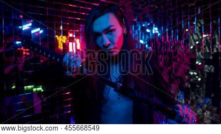 Male Transgender Neon Light Studio. Asian With Samurai Sword.