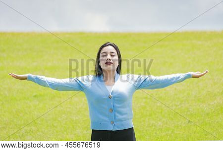 A Girl Spreading Her Arms In The Field, Attractive Young Woman Spreading Her Arms In The Field, Conc