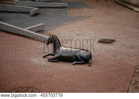 Riga, Latvia, 14 October 2021:  Bronze Statue Of Unicorn In Labyrinth At Playground, Facade Of Color