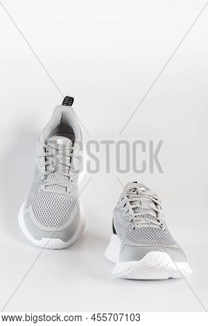 New Unbranded Running Sneaker Or Trainer On White Background. Men's Light Grai Sport Footwear. Close
