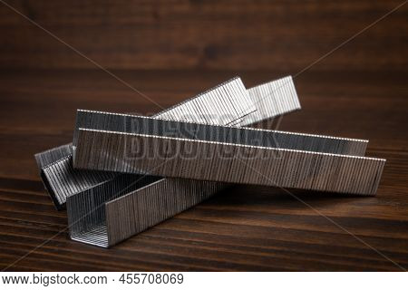 Metal Staples For Staple Guns On A Wooden Texture Background