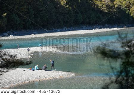 Wanaka New Zealand - April 27 2022; People With Small Burner Cooking Food Around Blue Pools On Makar