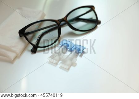 Single Dose Eye Drops, Glasses And Fabric On White Table
