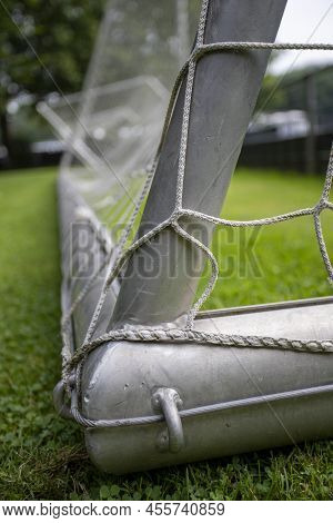 Close-up Of The Corner Of A Soocer Gold. Silver Steel And White Net