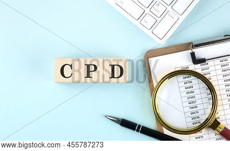 Cpd Word On A Wooden Cubes On Blue Background With Chart And Keyboard