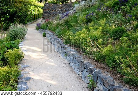 Road Cut Into The Slope. Above And Below The Road Is A Stone Dry Wall. Nature Trail Through The Autu