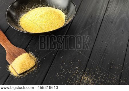 Corn Grits Polenta In Dark Bowl On Dark Background.