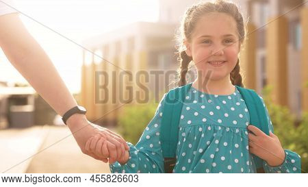 Back To School. Mom And Daughter A Go Hand In Hand To School For Lesson. Education Training Support 