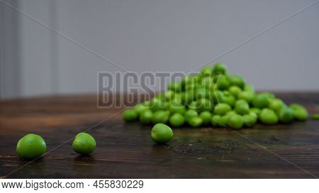 Fresh Peeled Green Pease On A Brown Wooden Table With Copy Space. Fresh Pods Of Green Peas Horizonta