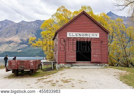 Glenorchy New Zealand - April 2022; Historic Red Railway Shed At Glenorchy With Mountain And Golden 