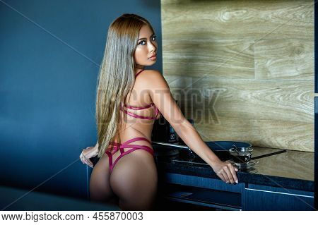Asian Woman In Dark Red Sexy Lingerie Posing At The Kitchen