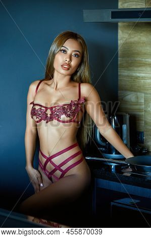 Asian Woman In Dark Red Sexy Lingerie Posing At The Kitchen