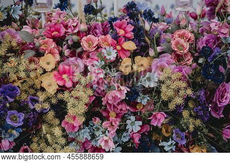 Big Bouquet Of Flowers In A Vase On A Gray Wall Background