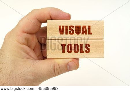 Business Concept. On A White Background, A Hand That Holds Wooden Blocks With The Inscription - Visu