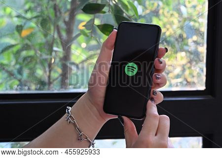Chiang Mai, Thailand - Mar 01, 2022: Woman Holding Iphone 11 Pro Max With Spotify Logo On The Screen