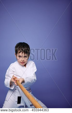 Waist-length Portrait Of Self-confident Child Boy, Teenager, Aikido Fighter In White Kimono, Trainin