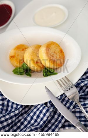 A Portion Of Three Round Curd Cheese Pancakes On A White Plate. Healthy Breakfast. Food Background. 