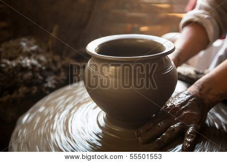 BHAKTAPUR, NEPAL - DEC 7: Unidentified Nepalese man working in the his pottery workshop, Dec 7, 2013 in Bhaktapur, Nepal. 100 cultural groups have created an image Bhaktapur as Capital of Nepal Arts.
