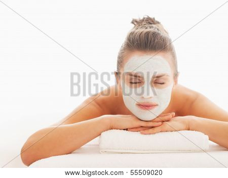 Relaxed Young Woman With Revitalising Mask On Face Laying On Mas