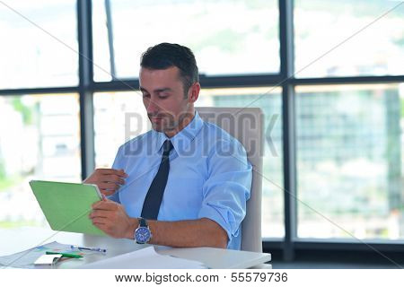 close-up of human hand  business man using tablet compuer at office