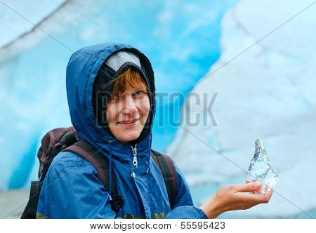 Woman With Ice Piece Near Nigardsbreen Glacier (norway)