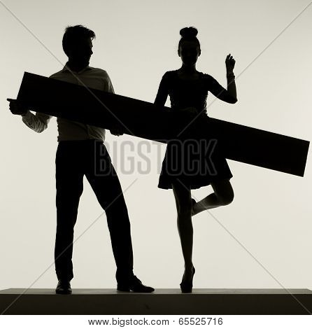 Young couple silhouette holding board