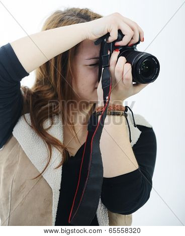 Girl posing for portraits in studio using camera