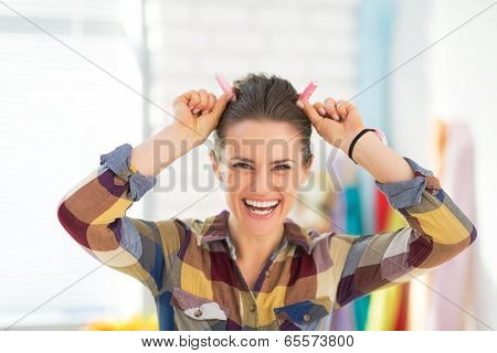 Portrait Of Happy Seamstress Making Horns Using Thread