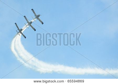 BERLIN, GERMANY - MAY 21, 2014: Aerobatic team 3x Fly Sinthesis Texan Top Class (Wefly team, Italy) performance during the International aviation and space exhibition ILA-2014.