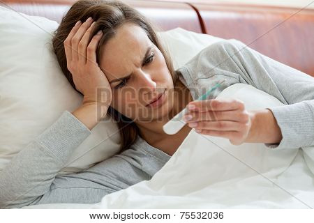 Getting The Flu Woman Taking Temperature