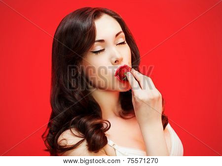 Beautiful Sexy Brunette Enjoying The Taste Of Fresh Strawberry