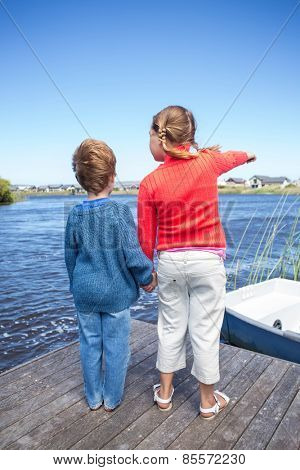 Happy sibings at a lake in the countryside