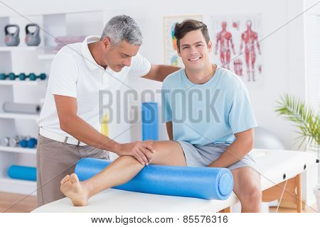Doctor examining his patient leg in medical office