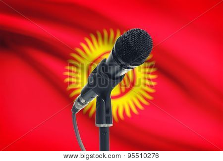 Microphone On Stand With National Flag On Background - Kyrgyzstan