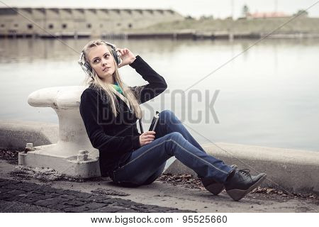 Girl with headphones and mobile phone