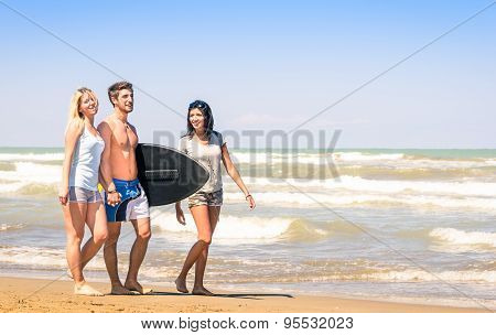 Group Of Young Happy People On Vacations At The Beach Holding A Surf Table - Best Friends