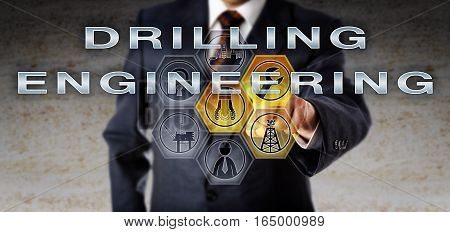 Manager in blue suit touching DRILLING ENGINEERING on an interactive computer screen. Oil and gas industry technology concept for technical support by engineers implementing safe drilling procedures.