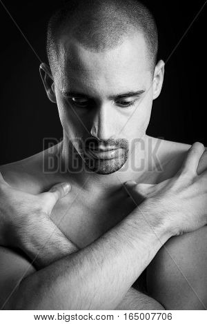 Natural portrait of guy in studio over black background