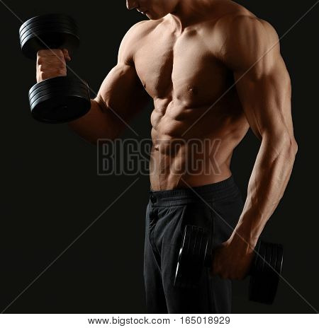 Muscles burning. Cropped shot of a shirtless bodybuilder working out with dumbbells showing off his toned torso