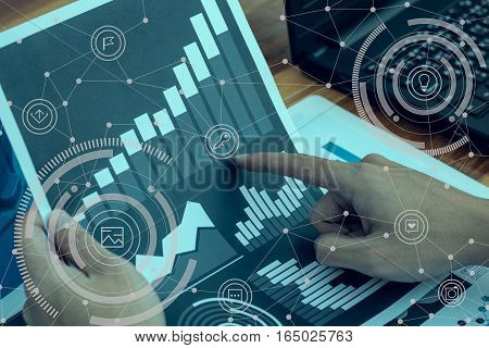 Business Workers Discussing Digital Graphs And Diagrams Indicating Progres