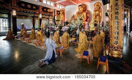 Ho Chi Minh City, Vietnam - November 27, 2015 - People praying in the buddhist temple Vinh Nghiem