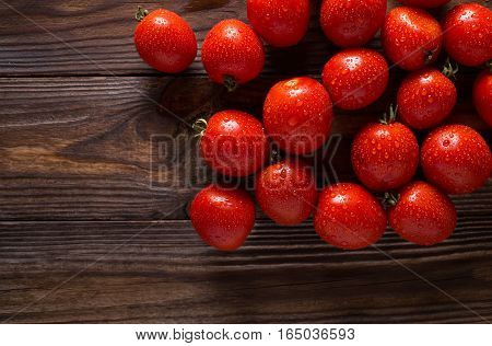 Red tomatoes with water drops. Tomatoes of different varieties. omatoes background. Fresh tomatoes Healthy food concept. Colorful festive still life. Loosely laid tomatoes in different positions.