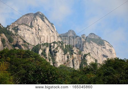Clouds hanging low on the mountains at the Dalong Waterfall scenic area in Yandangshan scenic area located in Zhejiang province China.
