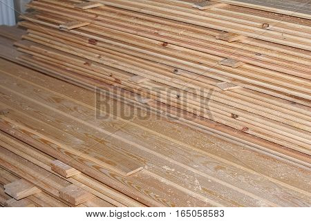 Stack of new wooden studs at the lumber yard, wall paneling