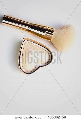 Makeup highlighter, make-up on Valentine's Day, shadow and brushes for make-up, make-up artist for the tools.