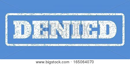 White rubber seal stamp with Denied text. Vector message inside rounded rectangular shape. Grunge design and scratched texture for watermark labels. Horisontal sticker on a blue background.